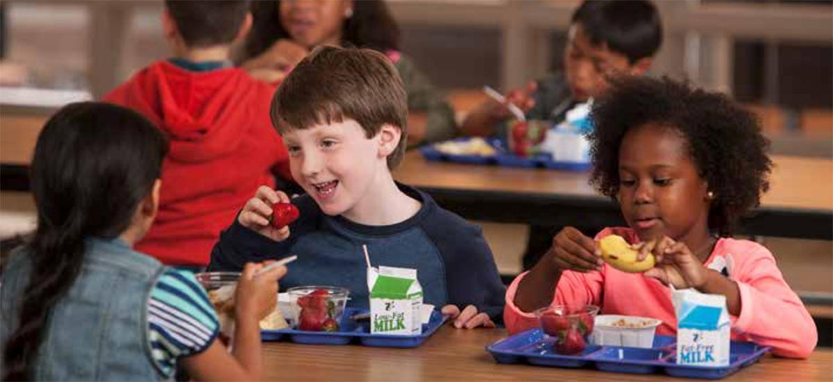 Children eating lunch in a school cafeteria.