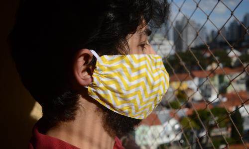 Person in yellow and white face mask.