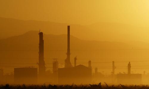 sun rises over the Kern Oil and Refining Co. refinery